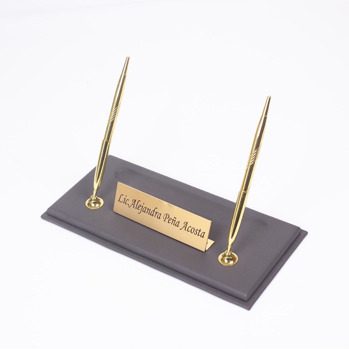Gray desk nameplate base with two gold-tone pens and a personalized gold-tone plate