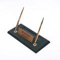 Dark green desk nameplate base with two gold-tone pens and a personalized gold-tone plate