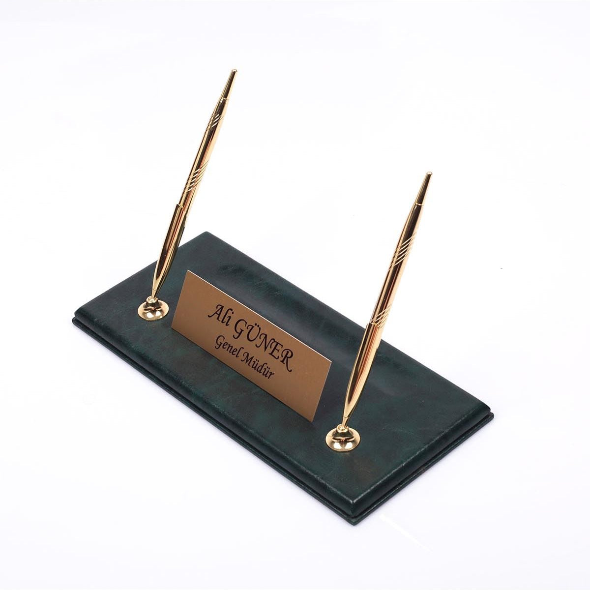 Dark green desk nameplate base with two gold-tone pens and a personalized gold-tone plate