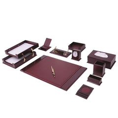Burgundy desk accessory arrangement with a writing pad, two-tier document tray, clock, tissue box and gold-colored pens.