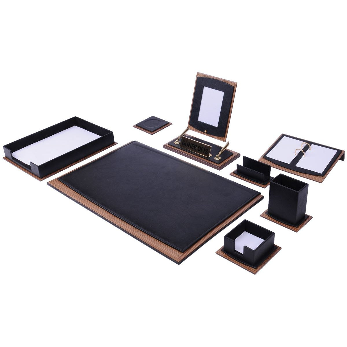 A matching desk organizer set featuring a large black desk mat with a brown leather-look border, a black tray, a black stand with a white insert, a black notebook, a black folder, and small black boxes, all arranged on a plain white background.