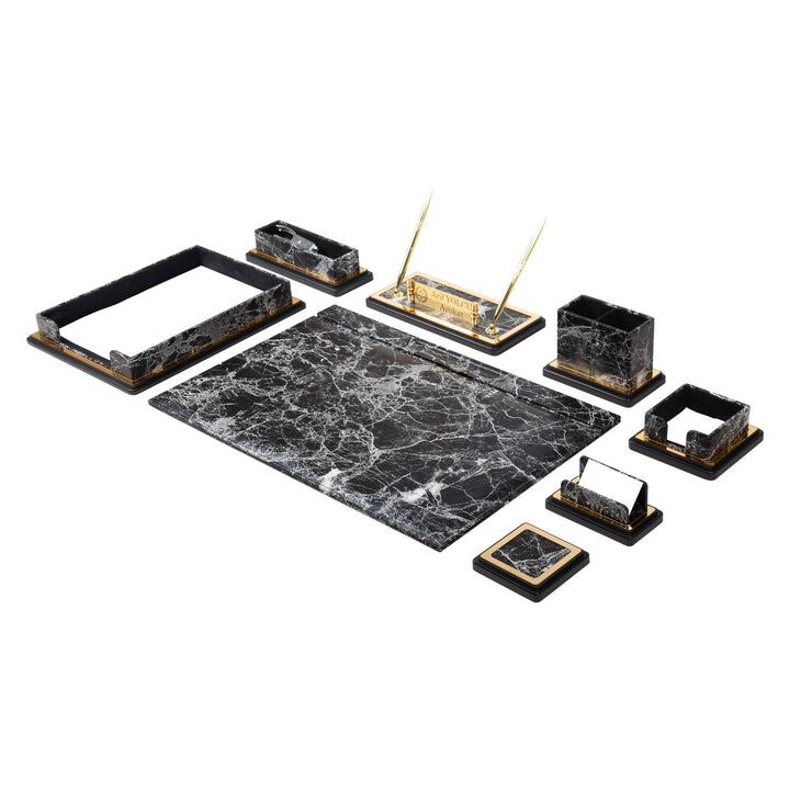 Gray and black marble-pattern desk accessories with a writing pad, document tray, gold-colored pen stand and small holders.